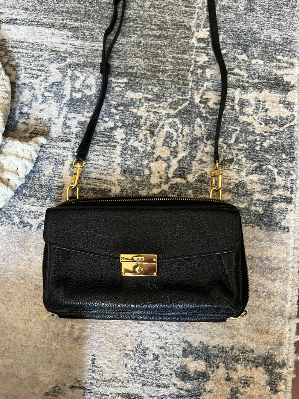 Tumi Black Leather Crossbody Wallet with Gold-Tone Lock